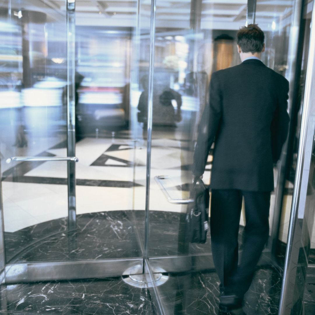 Depiction of financial services and insurance churn as a customer rotates out of a bank entrance.