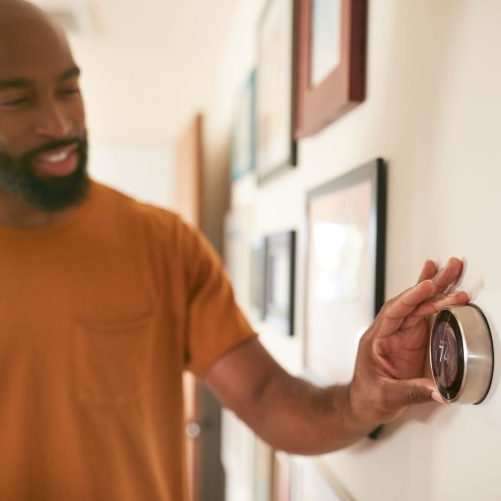 Man adjust home heating as JD Power reports household utilities rise in 2025