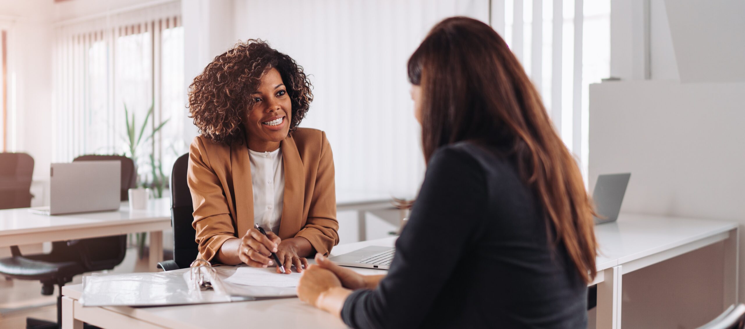 Woman at a desk talking to customer