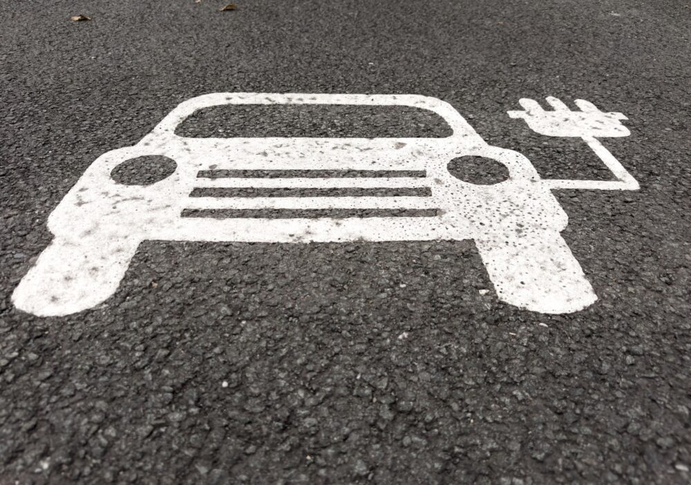 Electric Vehicle Charging Symbol Sign Painted on Asphalt