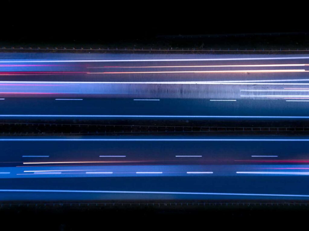 Aerial view, view from above, drone view, or birds eye view of a highway at night.