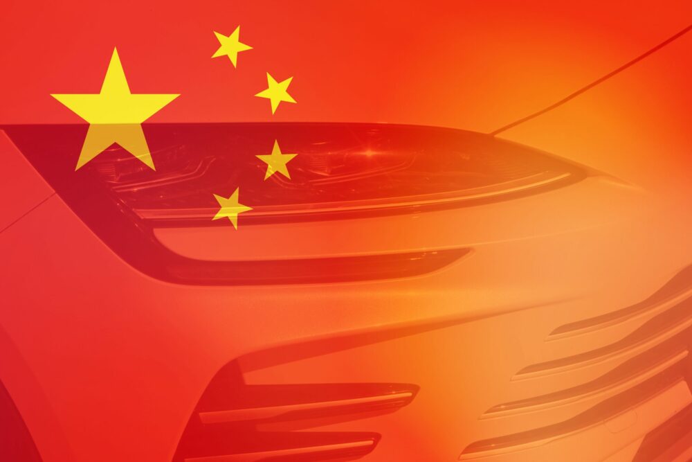 Chinese flag with a headlight of a car||||