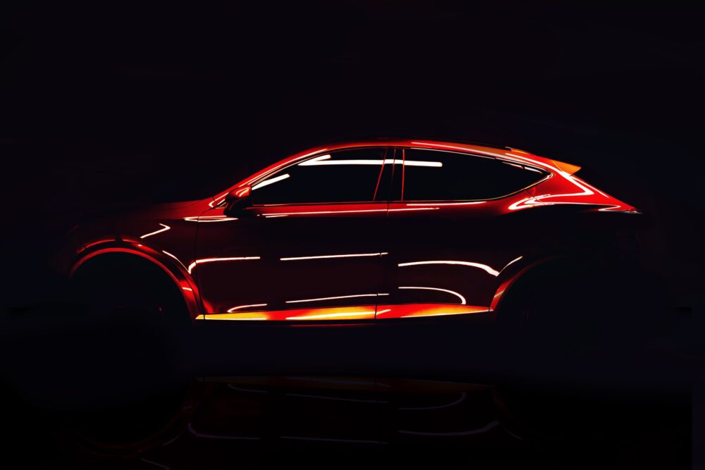 Futuristic red sports SUV illuminated by neon light in a dark studio.||||||||||||