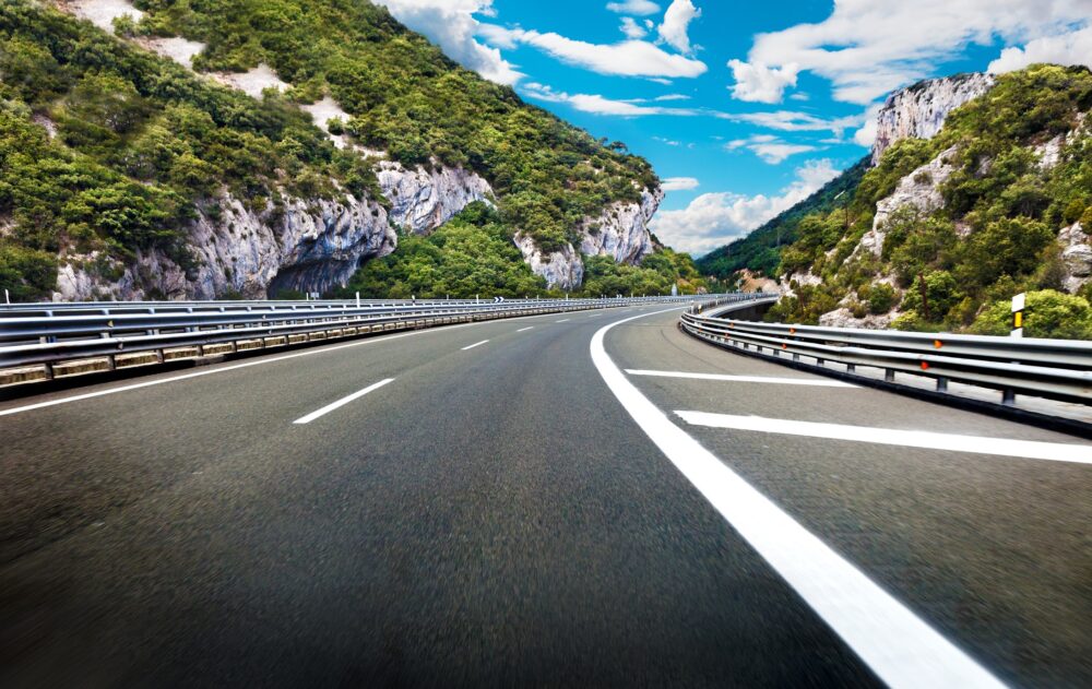 Curve of the highway to the destination. Concept of enjoying the trip and the beauty of the landscape|