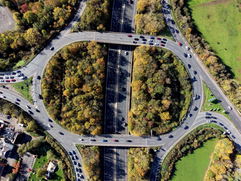 Aerial view over road traffic. Highway and overpass with cars and trucks