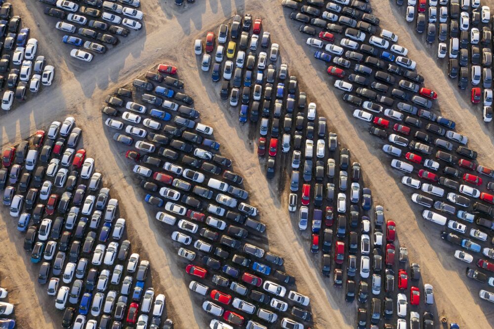 Aerial view of stockpiled used cars.|||